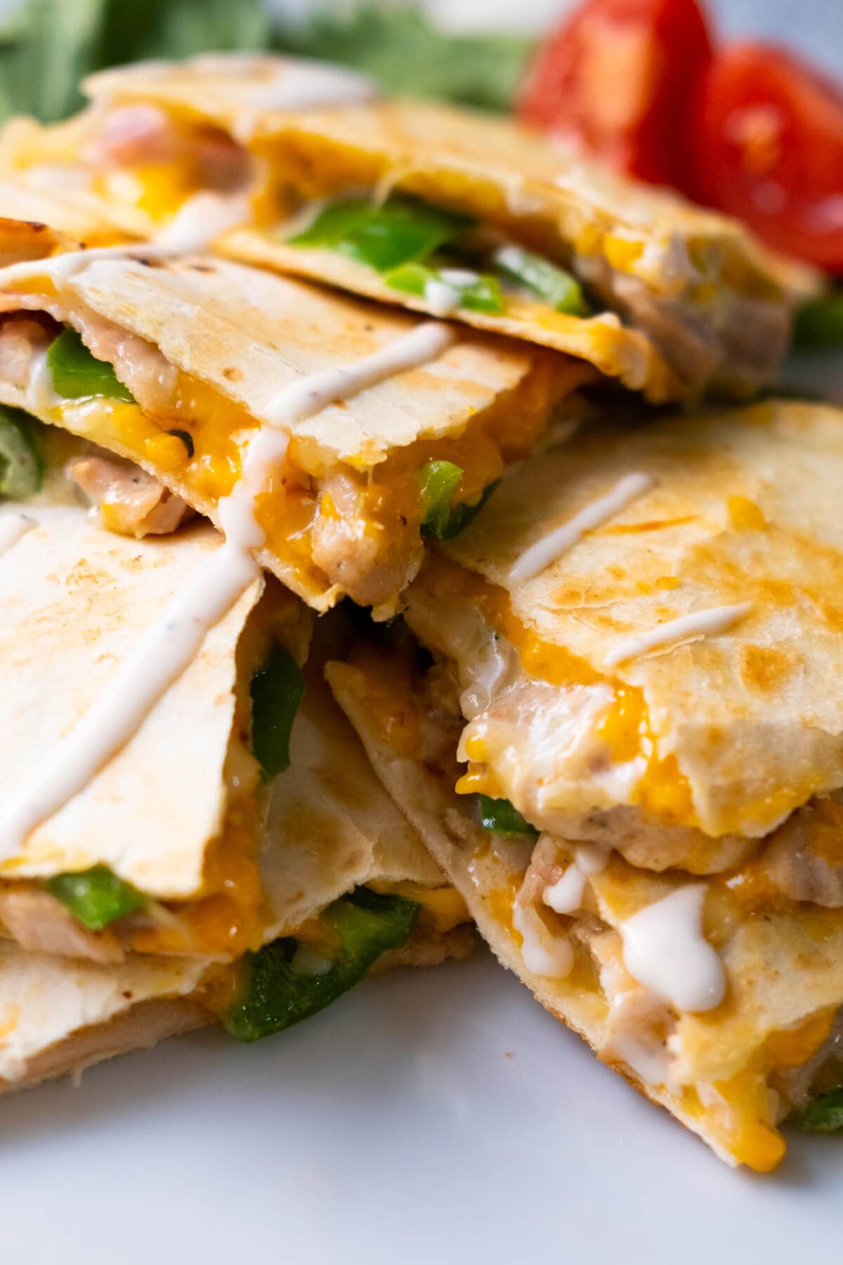Cheesy chicken and bacon quesadilla with ranch driezzling on top. 