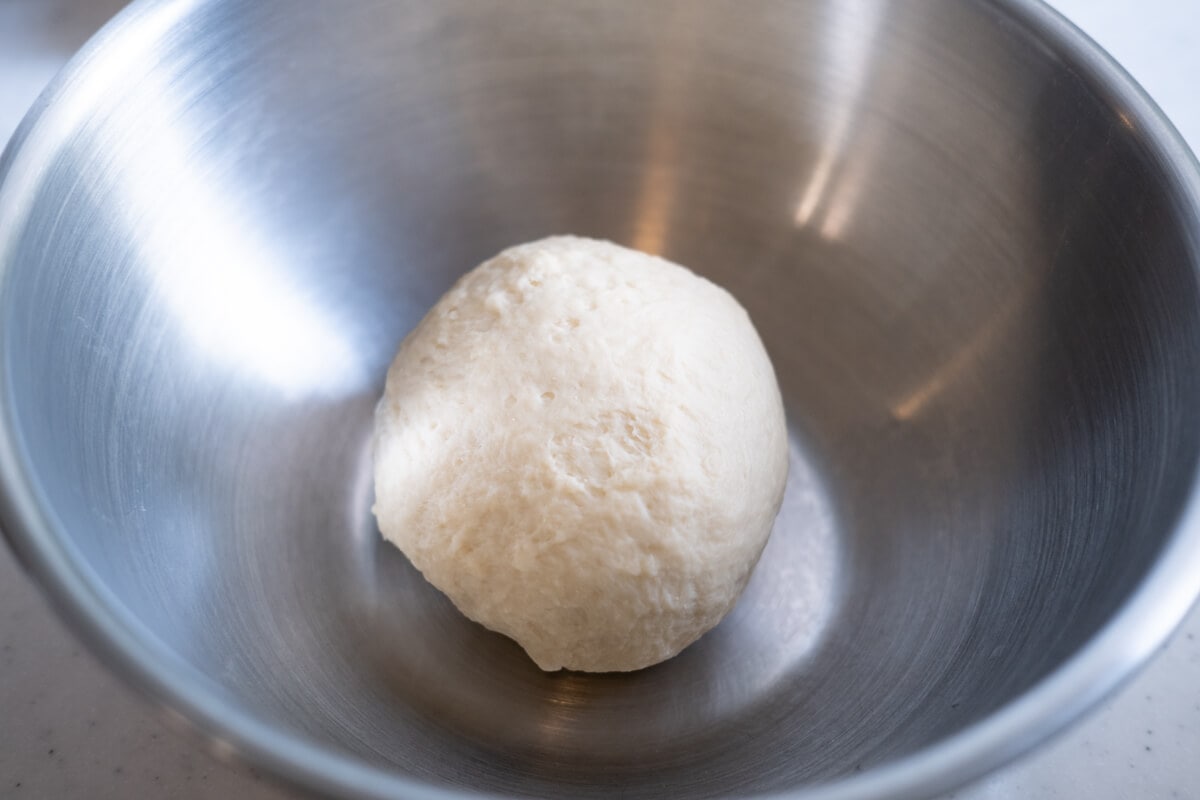 A smooth bread dough in a bowl. 