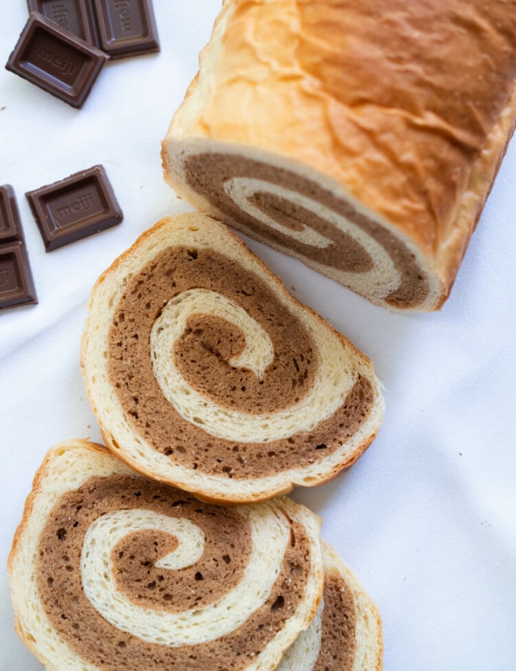 Chocolate cake bread with a few chocolate bar on the side.
