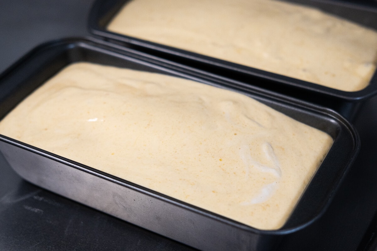 Pour the cake batter over the bread dough in a loaf tin. 