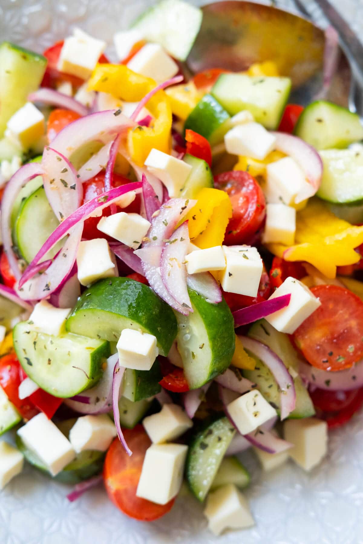 Greek salad with cheese on top. 