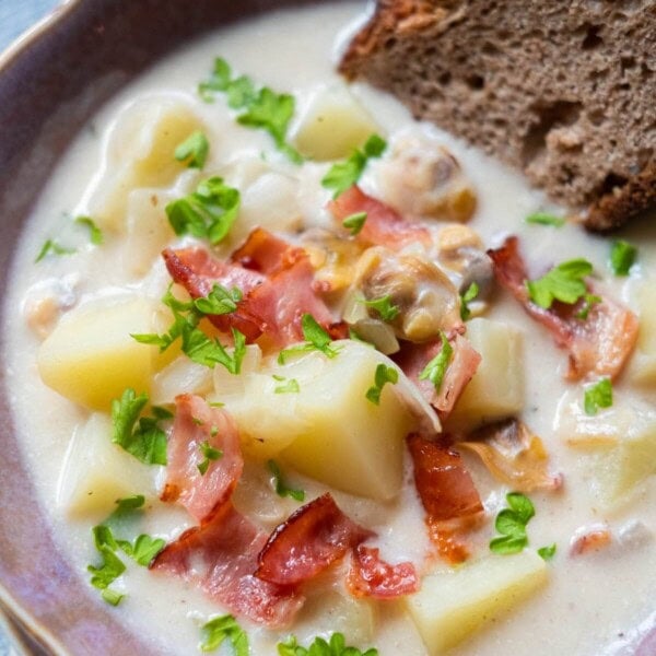 Creamy potato clam chowder served with sourdough bread.