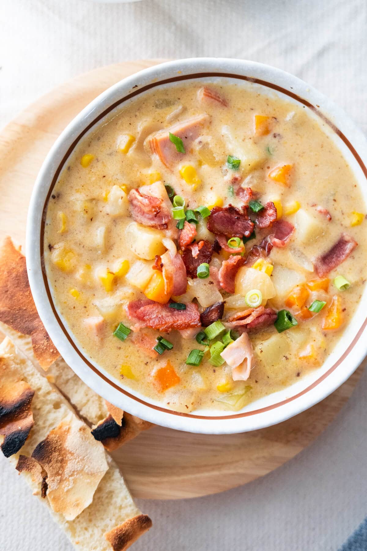 Creamy cheesy ham chowder filled with vegetables, ham, cheddar cheese and crisp bacon. 