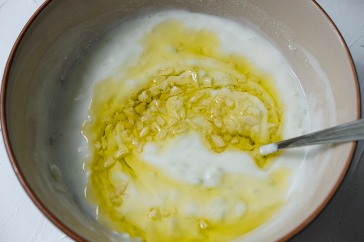 Combine yogurt with olive oil and garlic mix, and cucumber. 