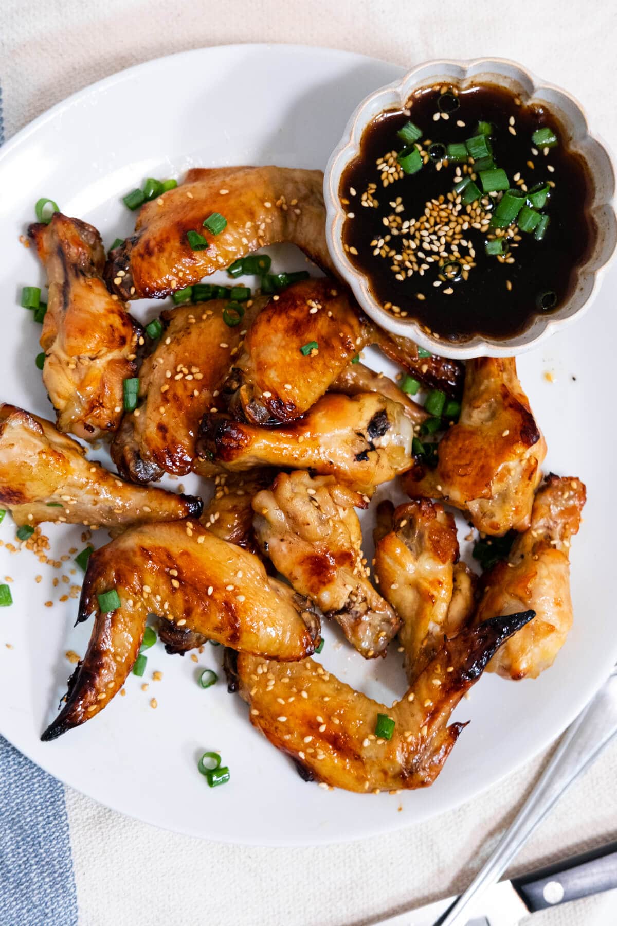 Golden brown Coca-Cola chicken wings served with a thick cola sauce aside. 