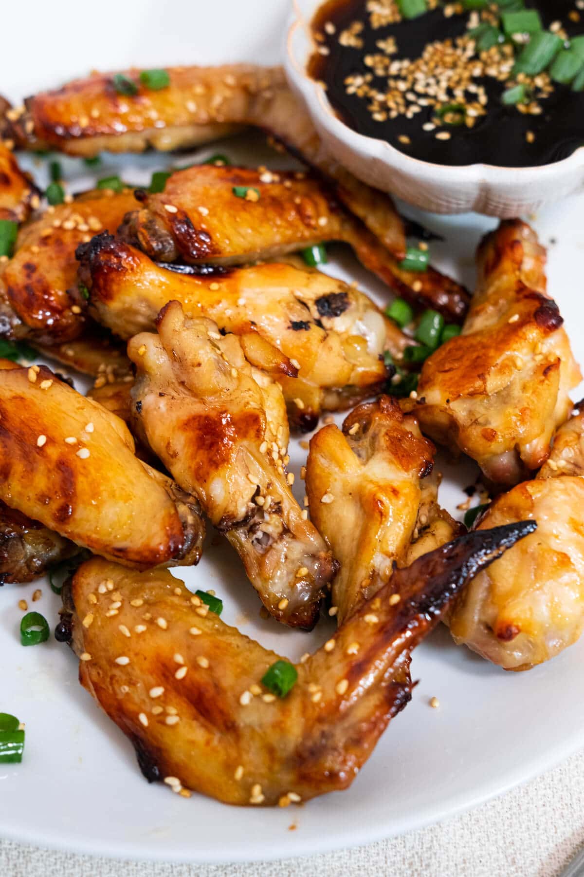 Delicious chicken wings with tender, juicy meat topped with chopped scallions and white sesame seeds. 