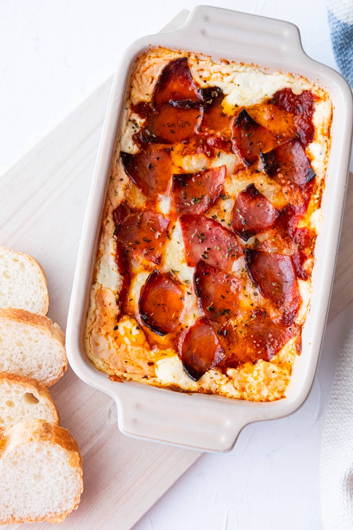 Pizza dip served with baguette slices. 