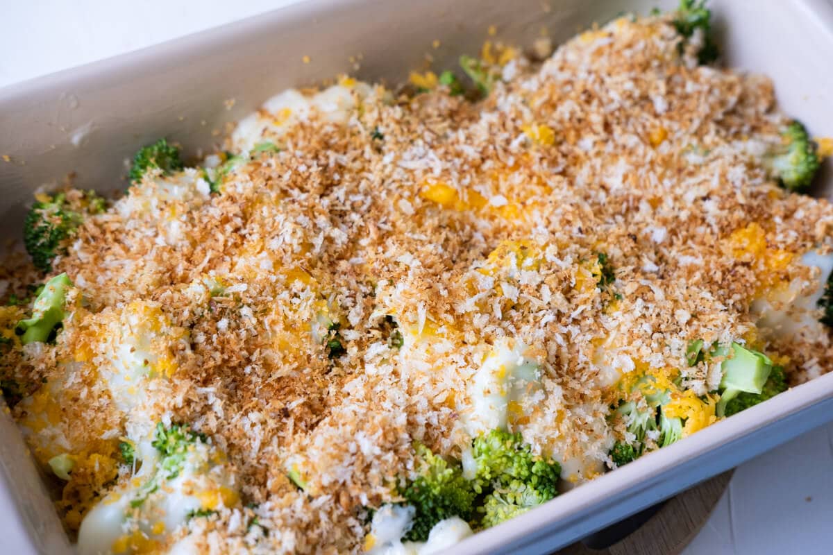 Arrange the broccoli to the baking dish and layer with creamy sauce, grated sharp cheddar cheese and top with bread crumbs. 