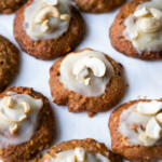 Cashew cookies recipe with frosting and cashew halves on top.