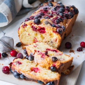 Moist cranberry cake with confectioner's sugar sprinkled on top.