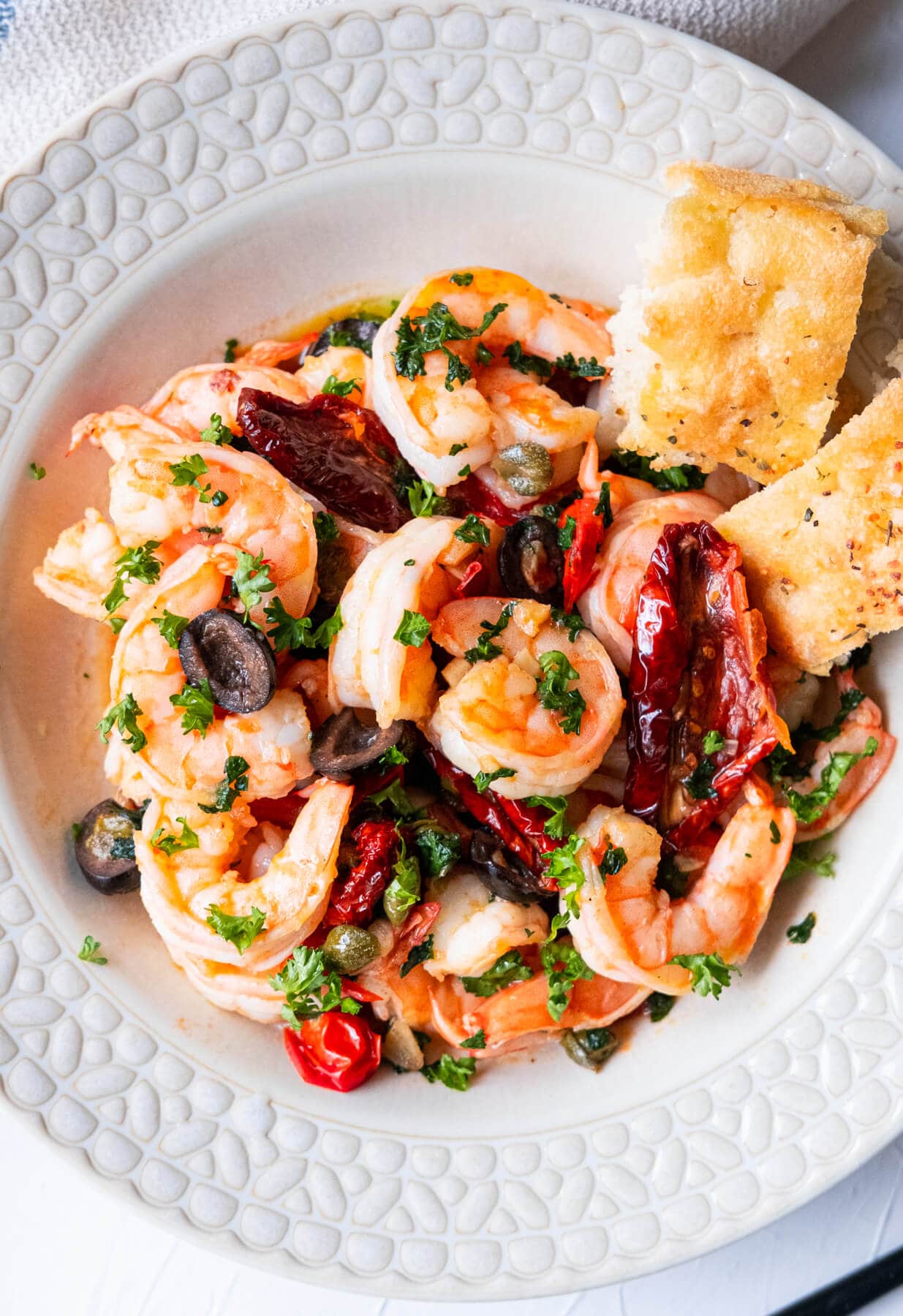 Large shrimp with sun dried tomatoes, cherry tomatoes, black olives, and capers in olive oil sauce. 