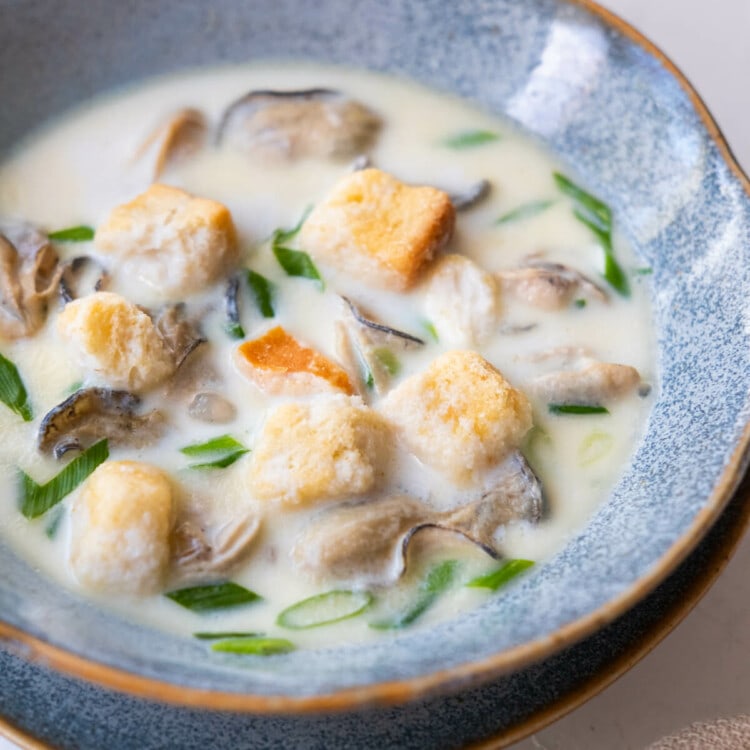 Oyster stew in milk-based broth and topped with croutons.