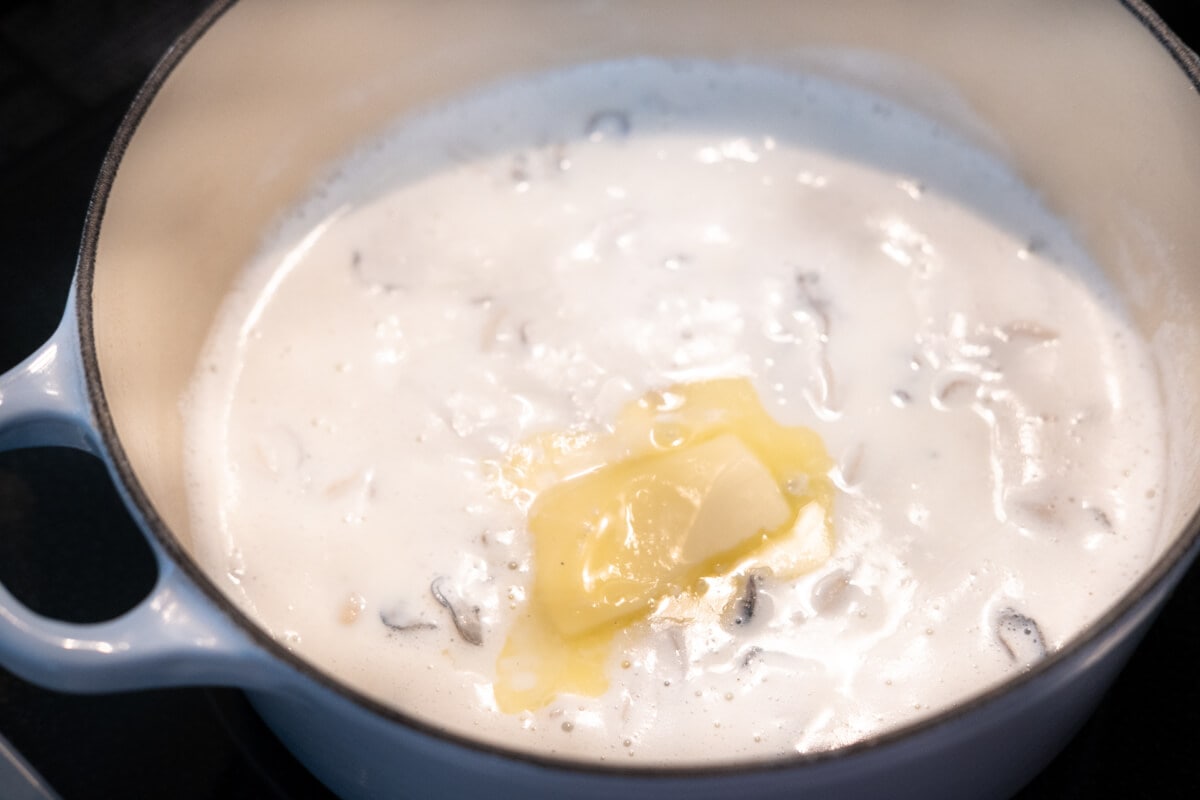 Add the butter to the oyster stew. 