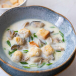 Oyster stew in a milk base broth with firm oysters and croutons.
