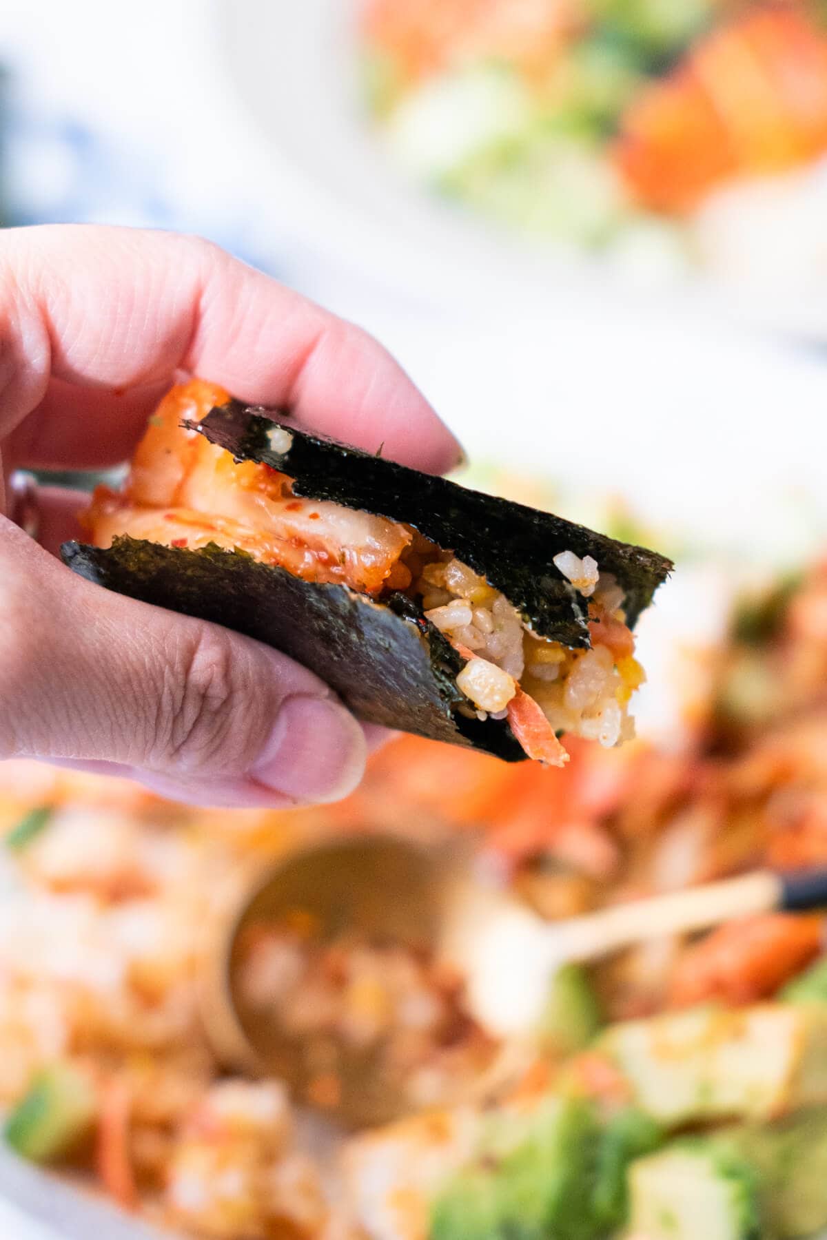 Nori wrapped salmon brown rice with kimchi inside. 