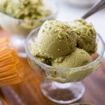Matcha ice cream in a glass ice cream cup.