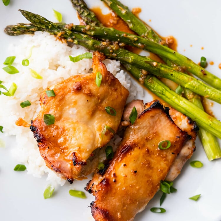 Miso-honey chicken and asparagus over white rice and sprinkled with chopped scallions.