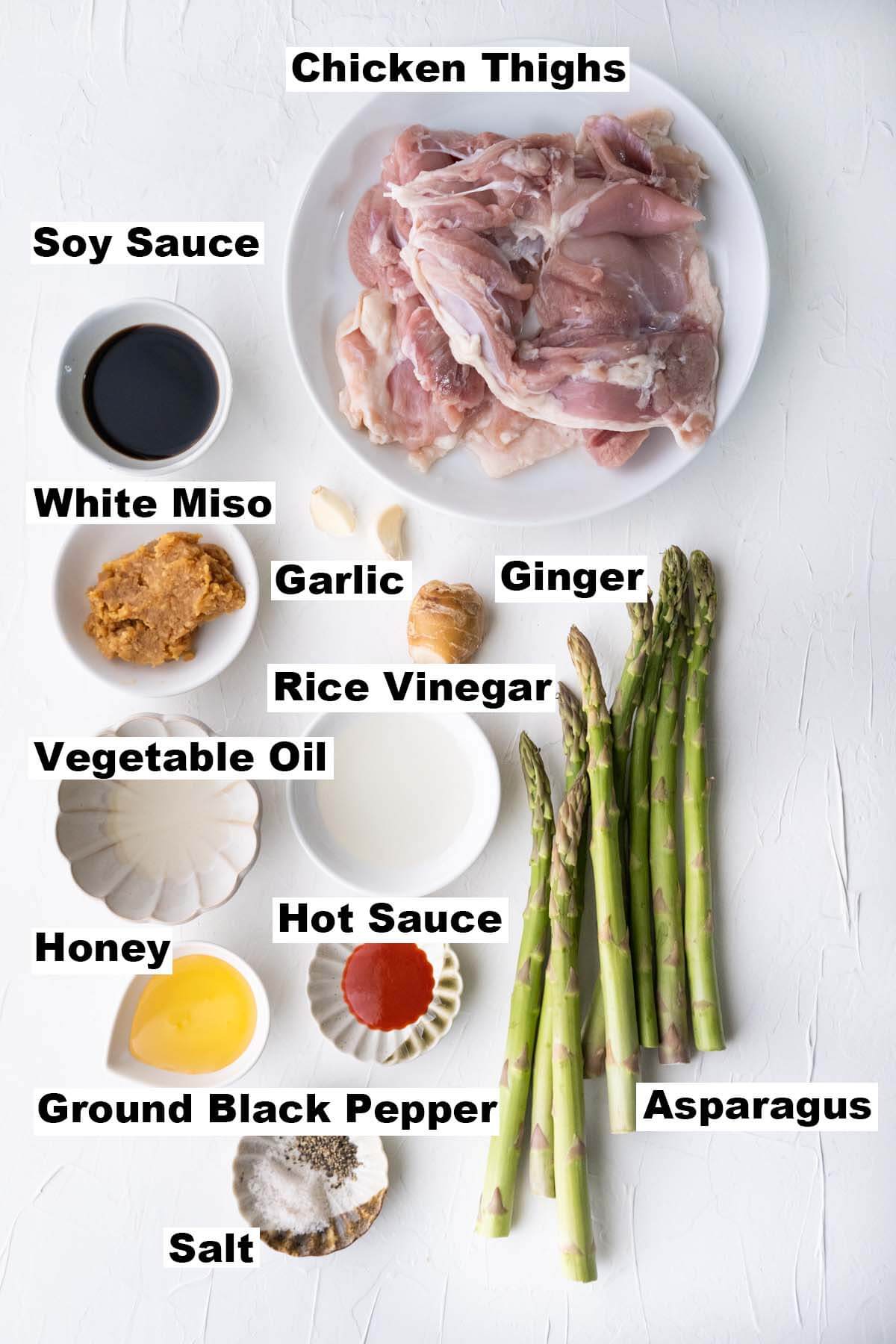 The picture shows ingredients of miso-honey chicken and asparagus recipe. 
