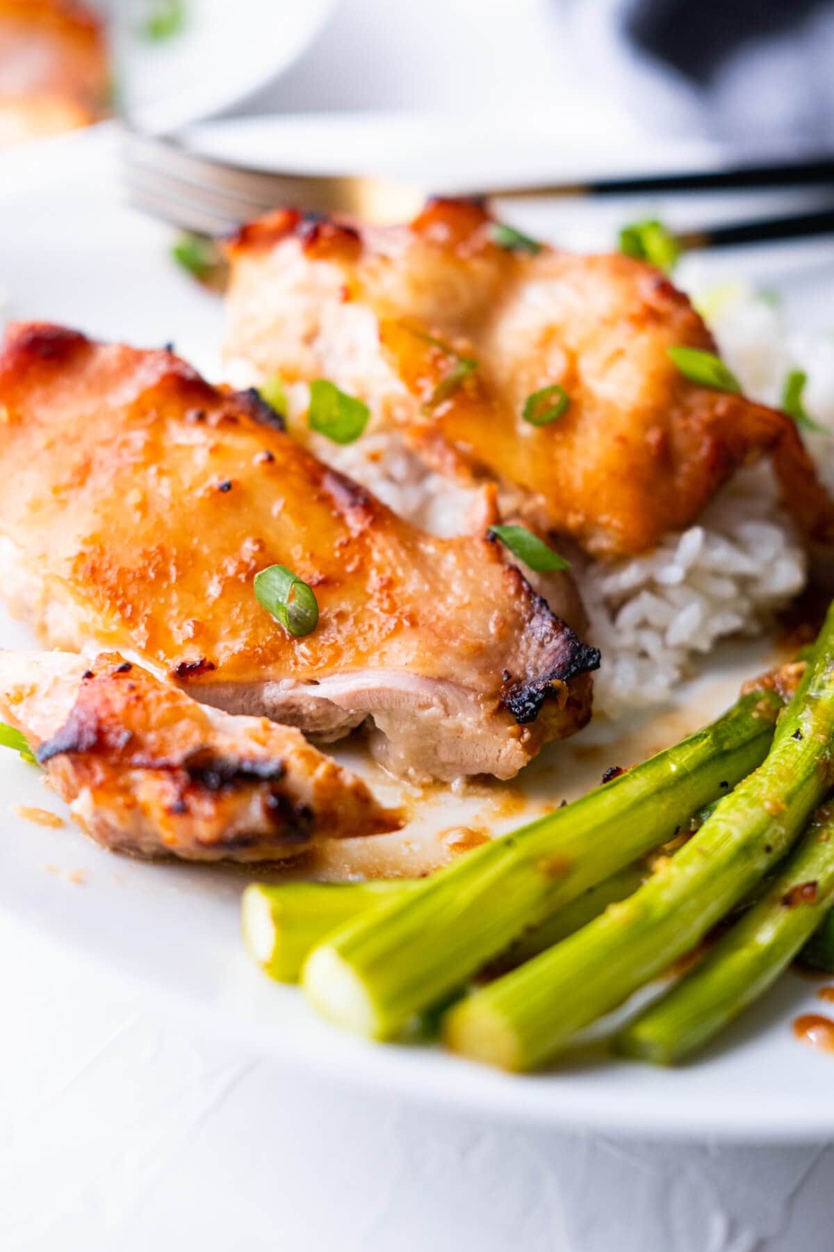 One chicken thigh is sliced into small piece, revealing its juicy and tender interior. 