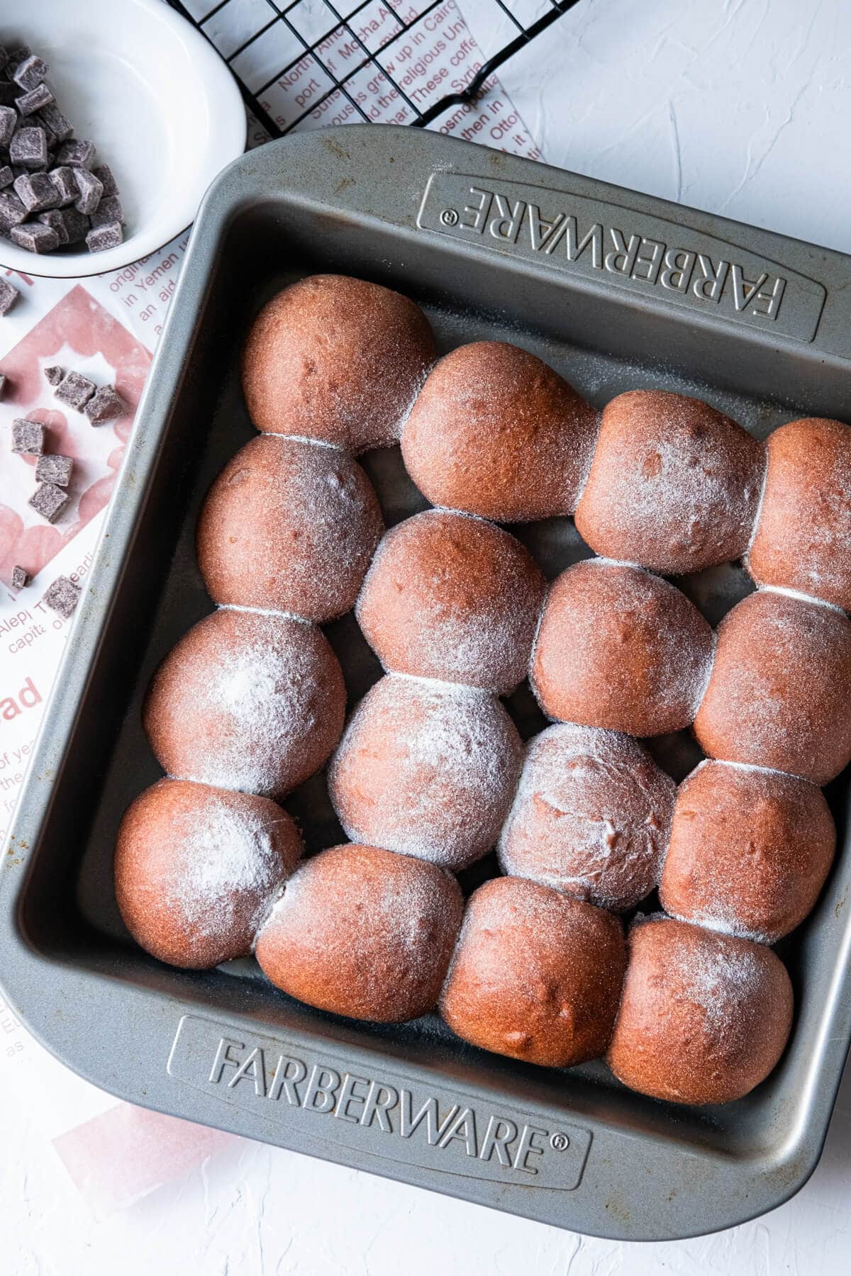 16 mini chocolate milk buns baked in a 9-inch square baking pan. 
