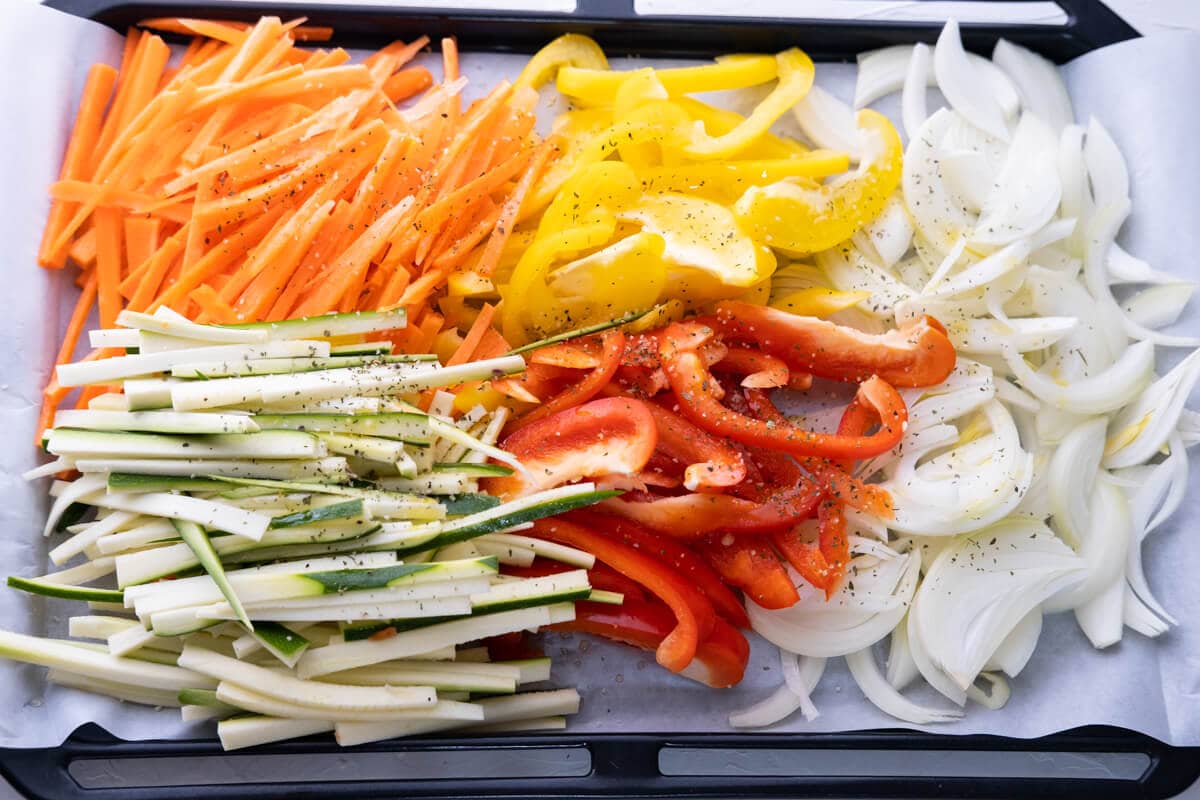 Cut all vegetables into similar thickness slices, season with salt, pepper, and dried Italian herbs, drizzle with olive oil, and placed on a large baking sheet lined with parchment paper. 