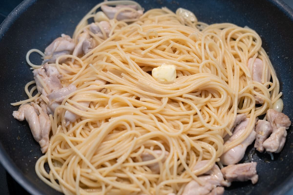Add pasta, cooked chicken and butter to the skillet, and cook until the butter melts. 