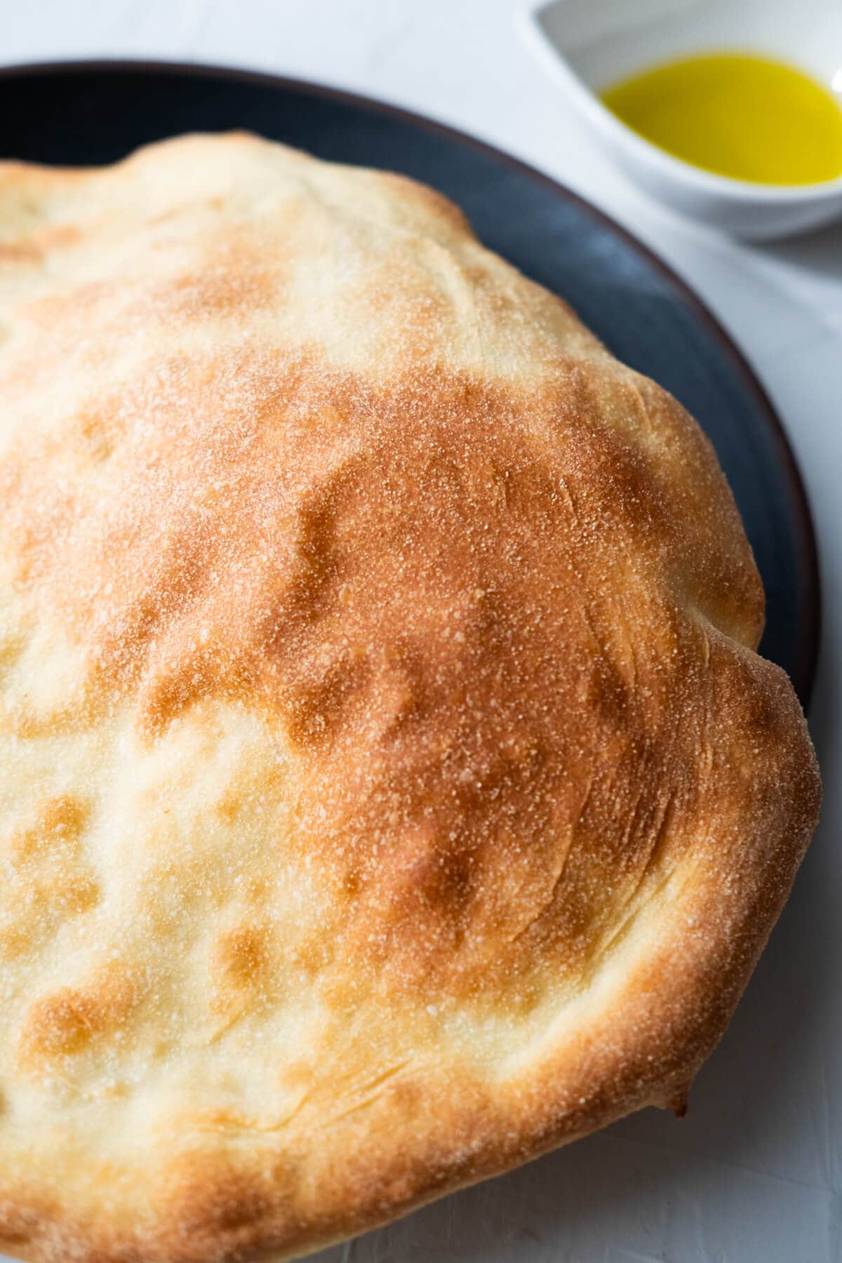 Baked puff bread served with olive oil.