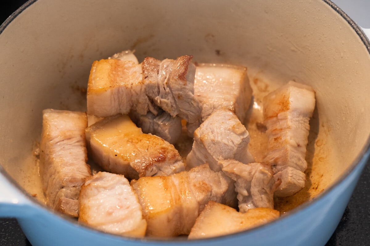 Sear the pork belly in a heavy-bottomed pot until slightly browned. 