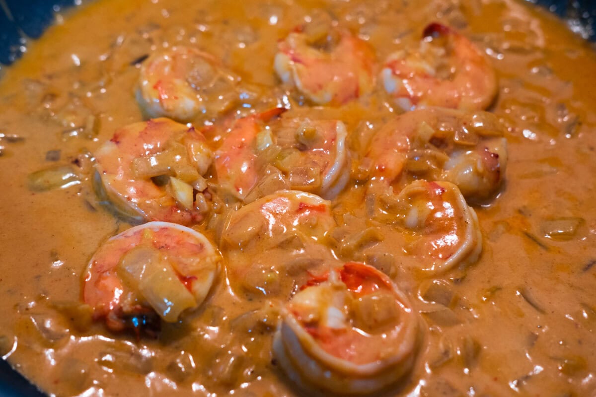 Shrimp with red coconut chili sauce in a skillet. 