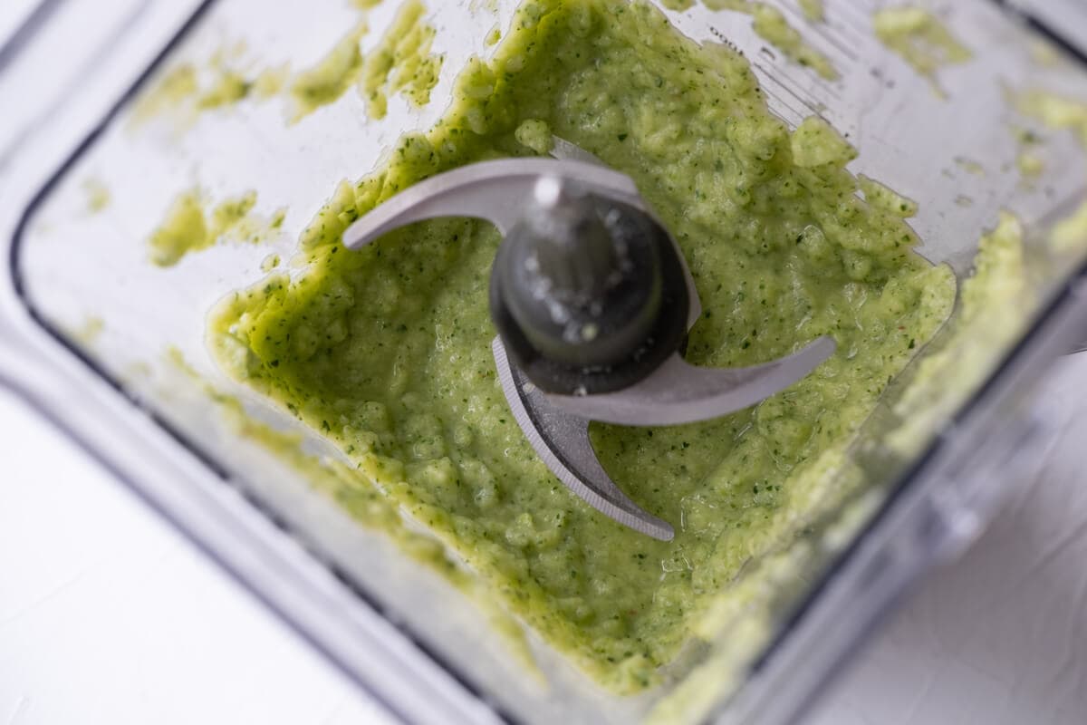 Blend the zucchini, grated parmesan, lemon juice, and sourdough until smooth using a food processor.