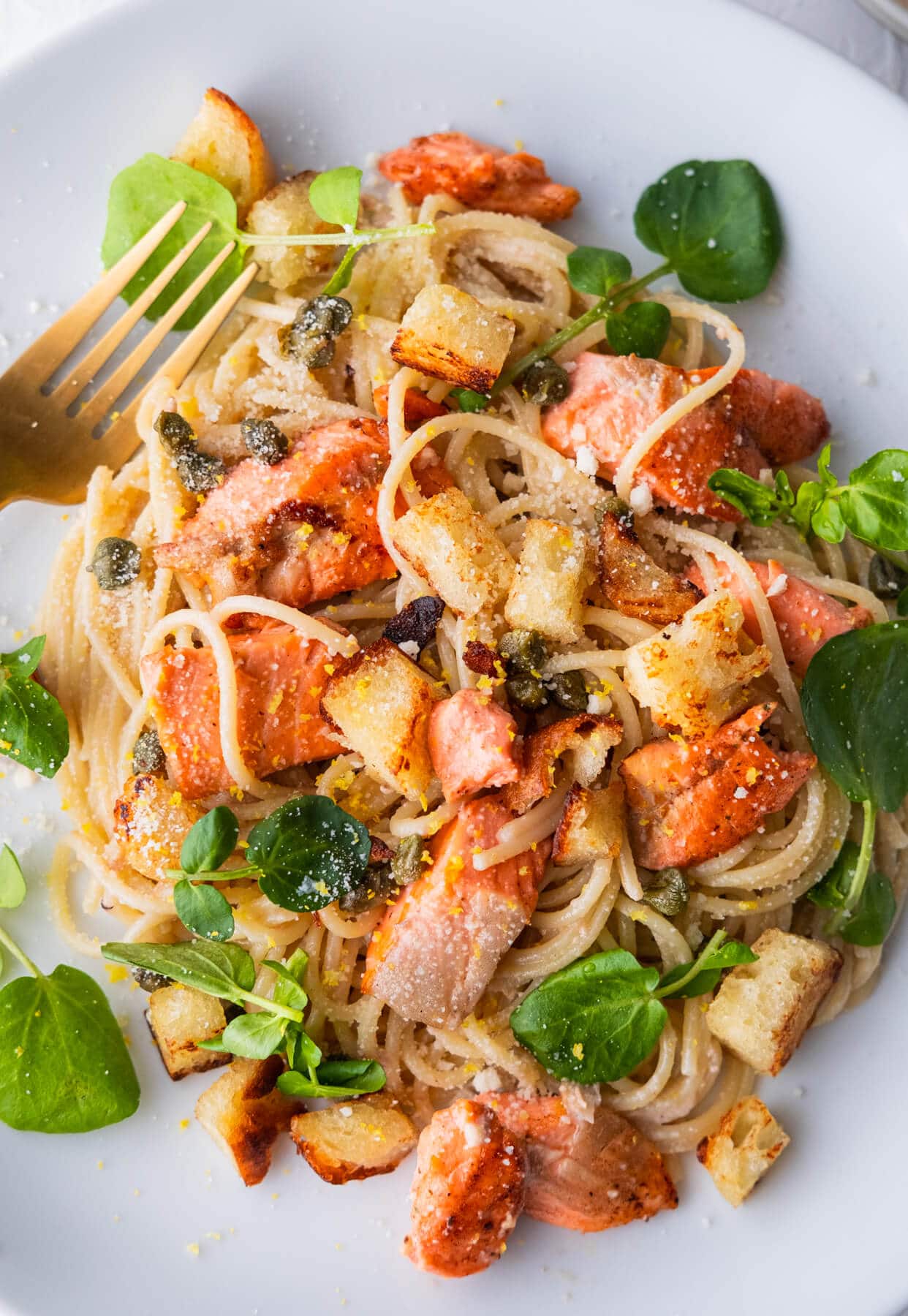 Salmon spaghetti with salmon cubes and baby capers, watercress leaves and grated parmesan. 