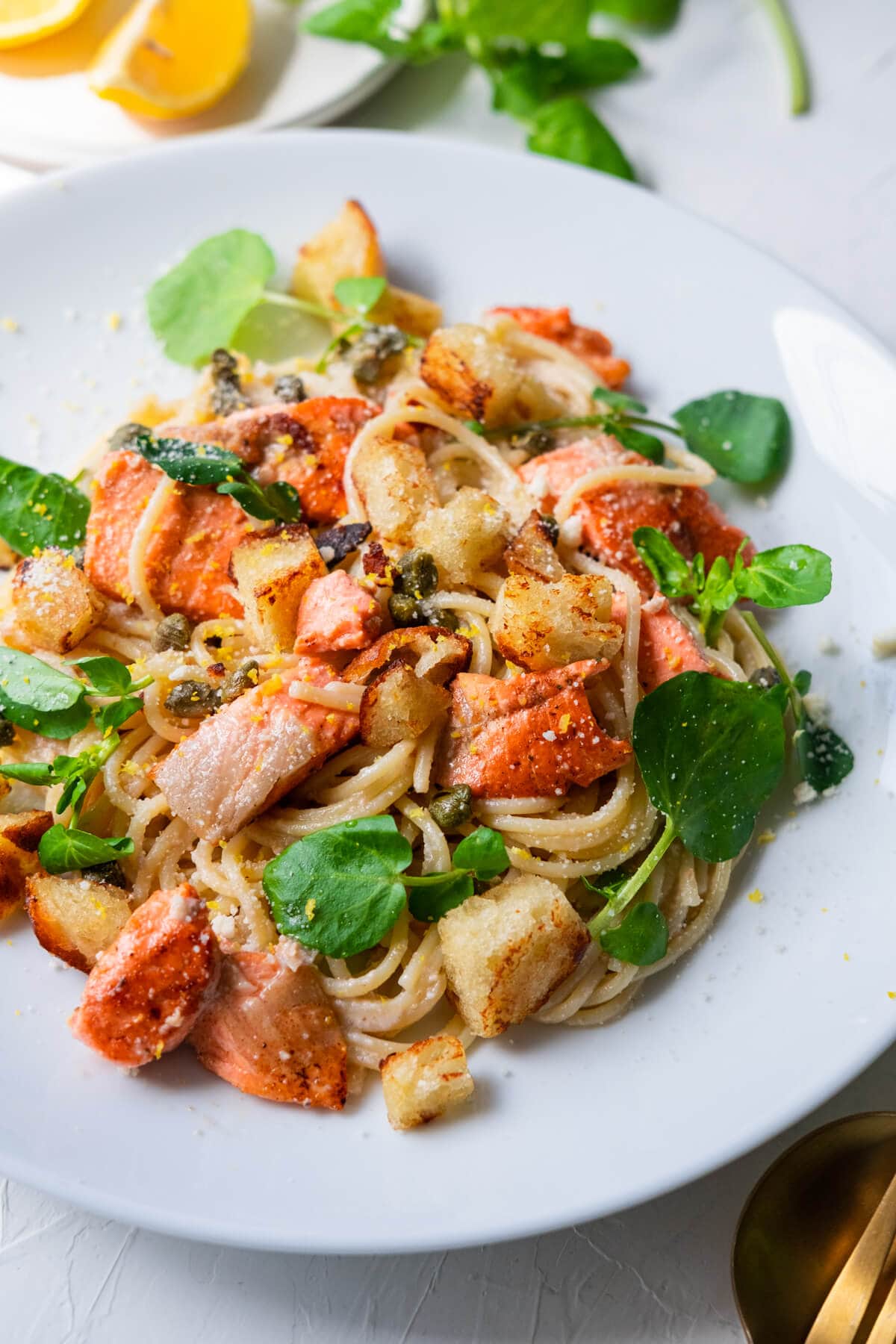 Spaghetti with salmon in creamy lemon and garlic sauce on a plate. 