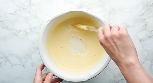 This image shows Sugar being added into the Banana Cake mixture.