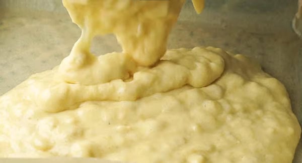 This image shows the Banana Cake batter being poured into the baking pan.
