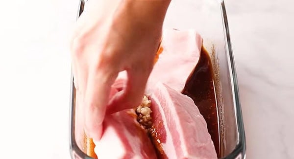 This image shows the Pork Belly being marinated.