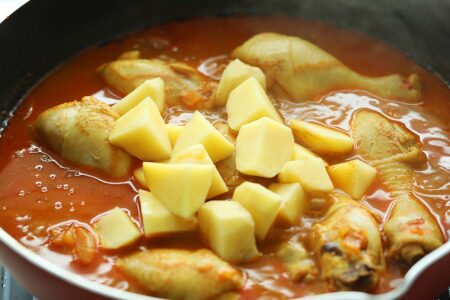 Malaysian curry chicken with potatoes in a pan. 