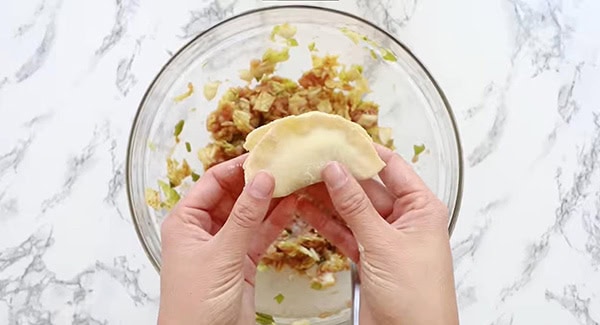 This image shows the Dumplings being sealed with water.