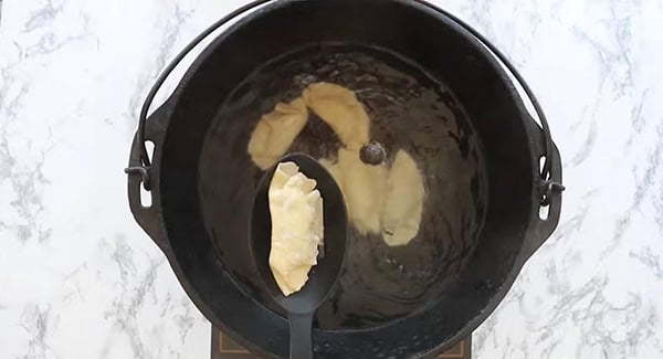 Chicken dumplings boiled in a pot.