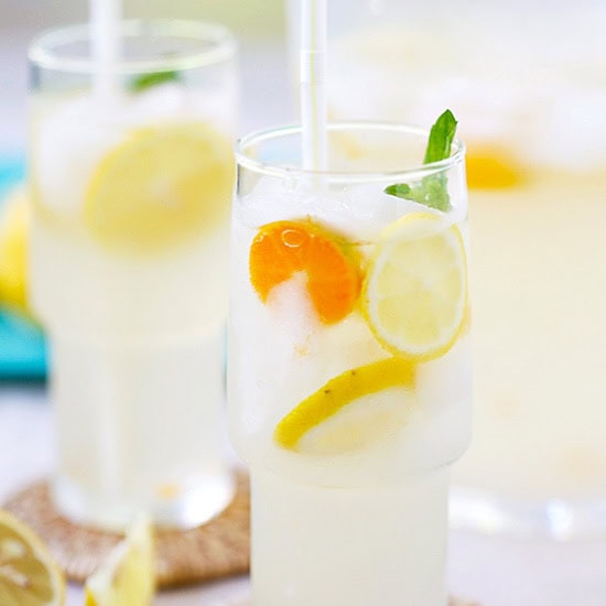 Coconut water lemonade served in a glass with lemon slices and mint. 