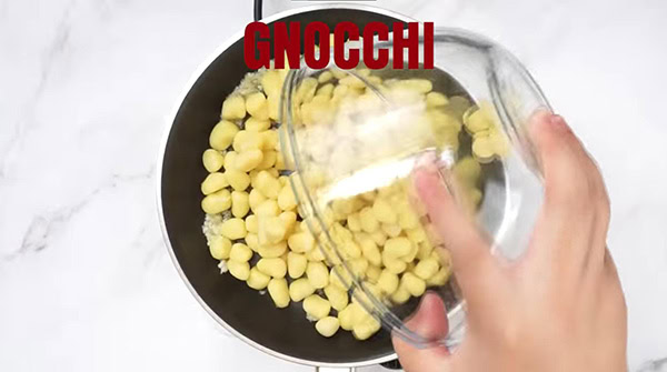 This image shows the Gnocchi being added into the skillet.