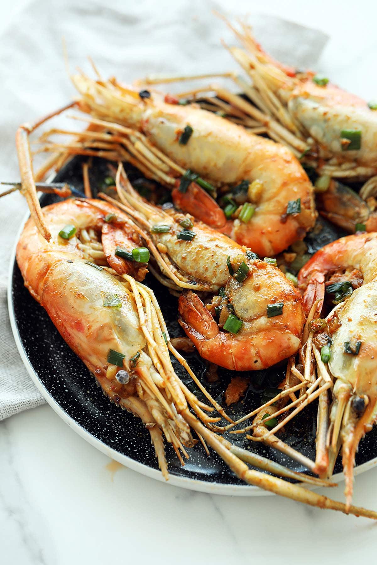 Pan Fried Prawns served on a plate.