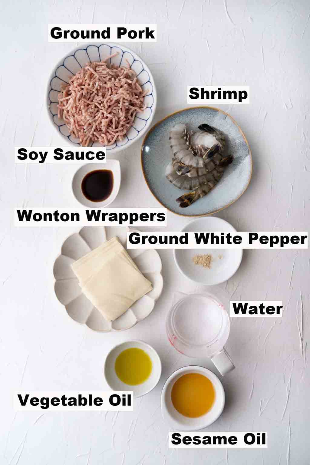 This picture contains ingredients such as ground pork, shrimp, soy sauce, wonton wrappers, ground white pepper, water, vegetable oil and sesame oil which are needed to make the Fried Wonton recipe.