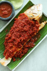 Grilled fish marinated with sambal on top of the fish