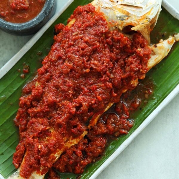 Grilled fish marinated with sambal on top of the fish