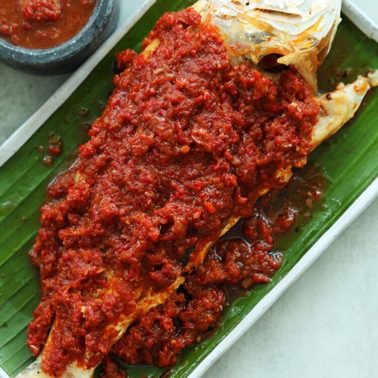Grilled fish marinated with sambal on top of the fish