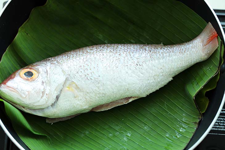 This image shows the Fish on the Banana Leaf in a pan.
