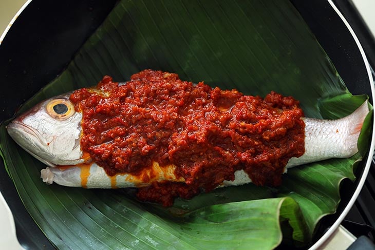 This image shows the Sambal Belacan Being added on to the Fish.