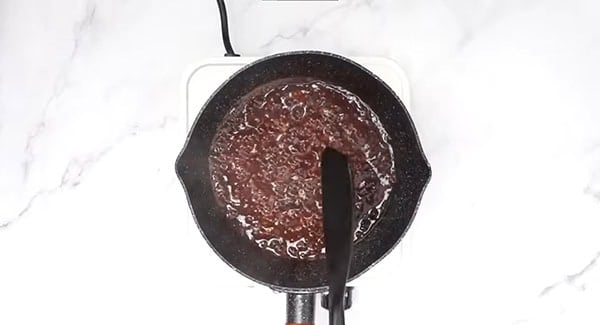 This image shows the sauce being cooked in a pot.