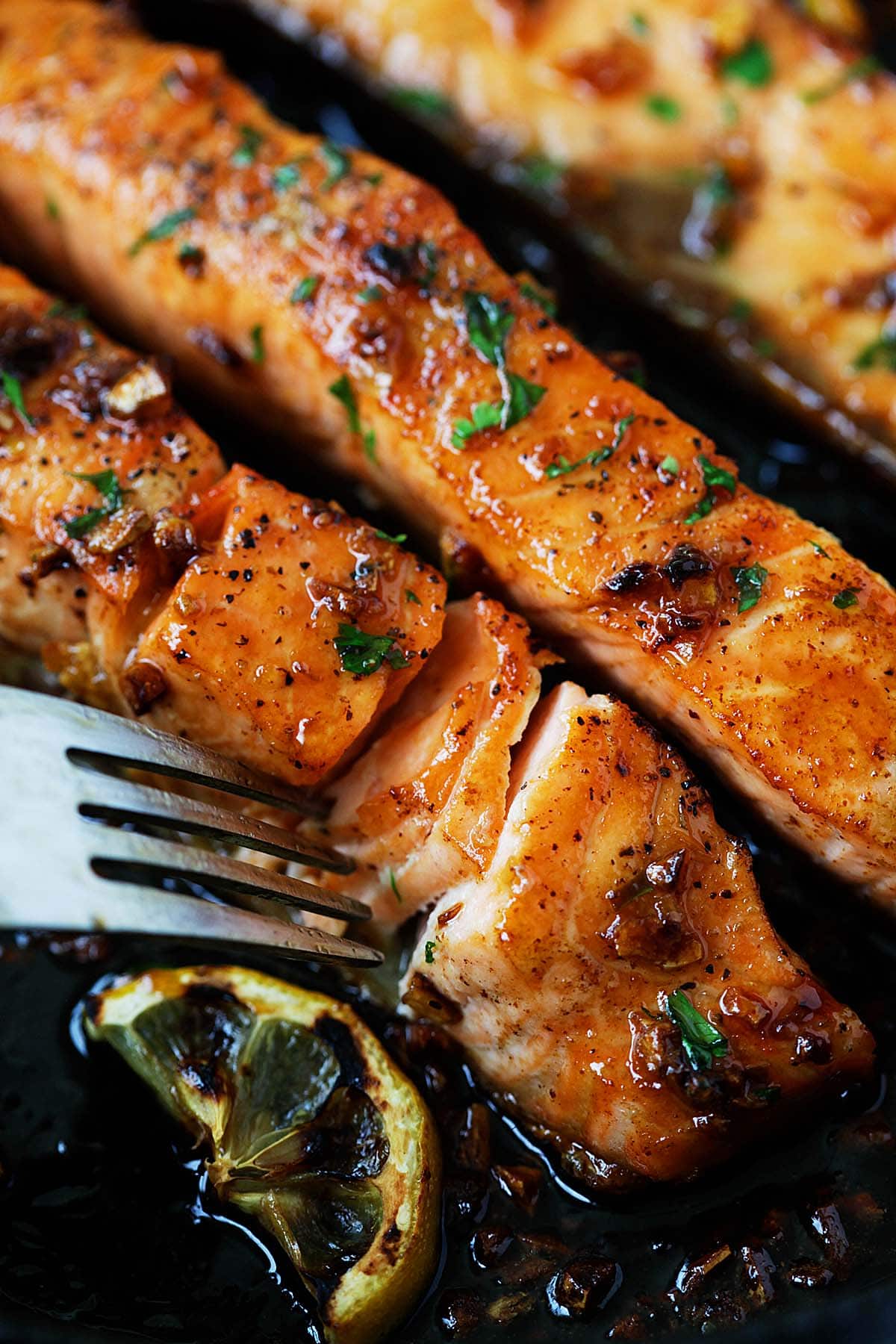 Salmon recipe with honey garlic glaze on a skillet. 