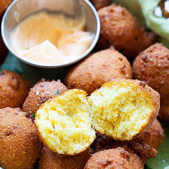 Homemade hush puppies served with dipping sauce. 